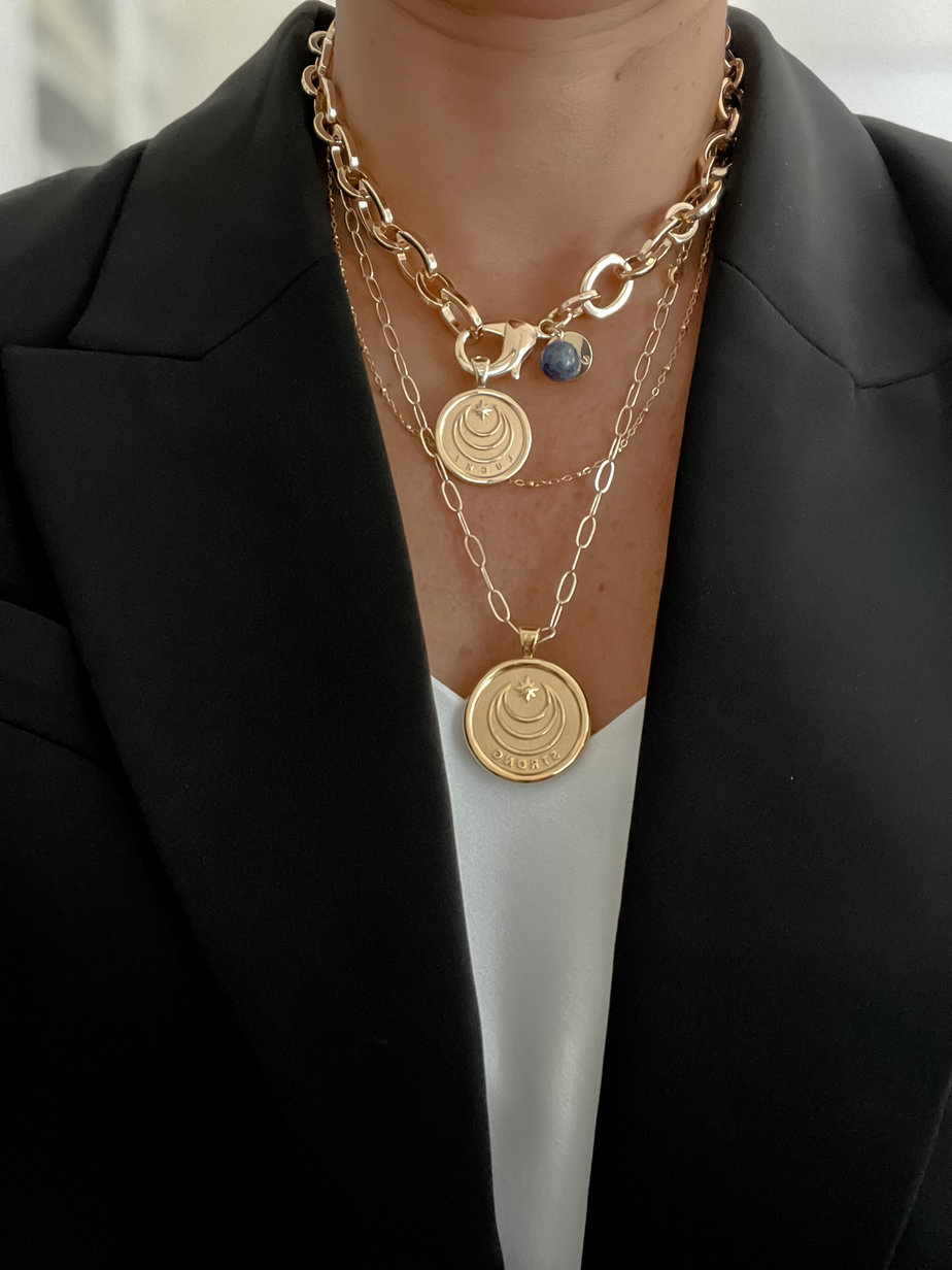 2 gold necklaces layered on a neck to show how to layer jewelry