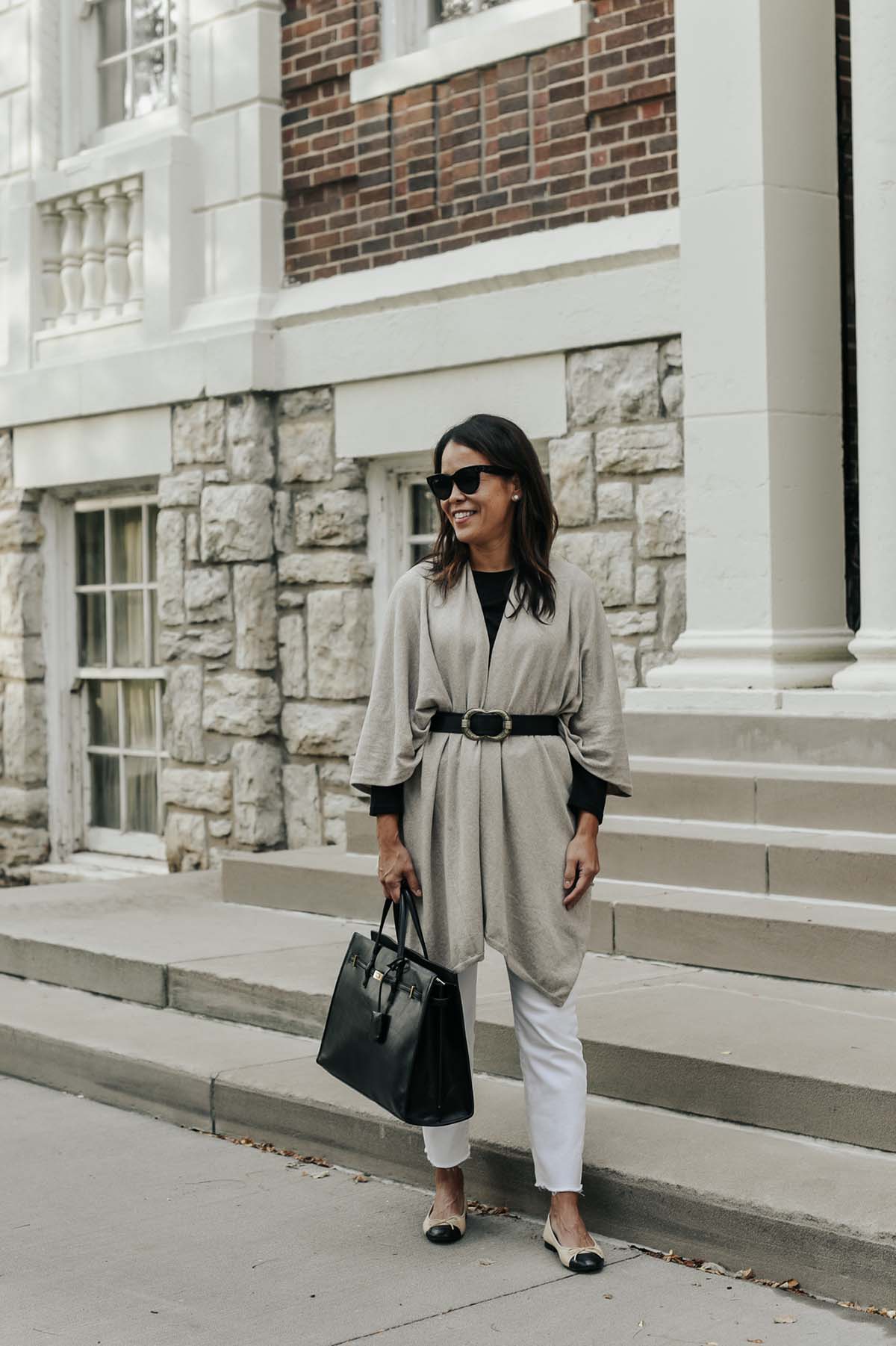wearing white jeans, black handbag, chanel flats, taupe wrap