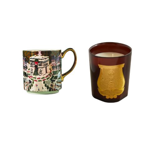 mug with paris city scence at the holidays and red candle next to eachother