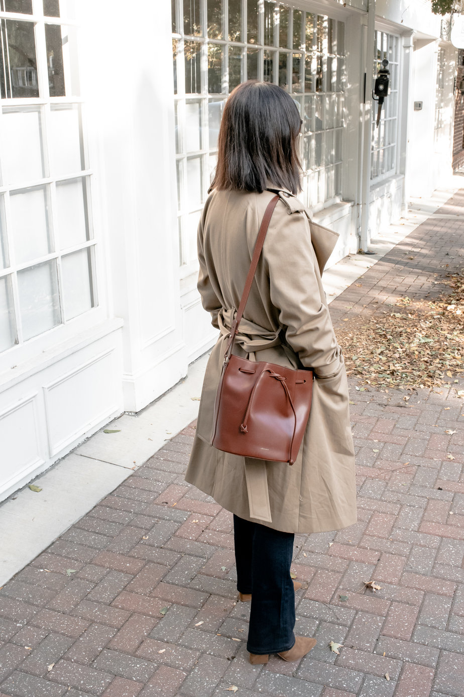 lady with trench coat, long dark denim, brown bucket bag which are part of my sezane pieces for fall to wear.
