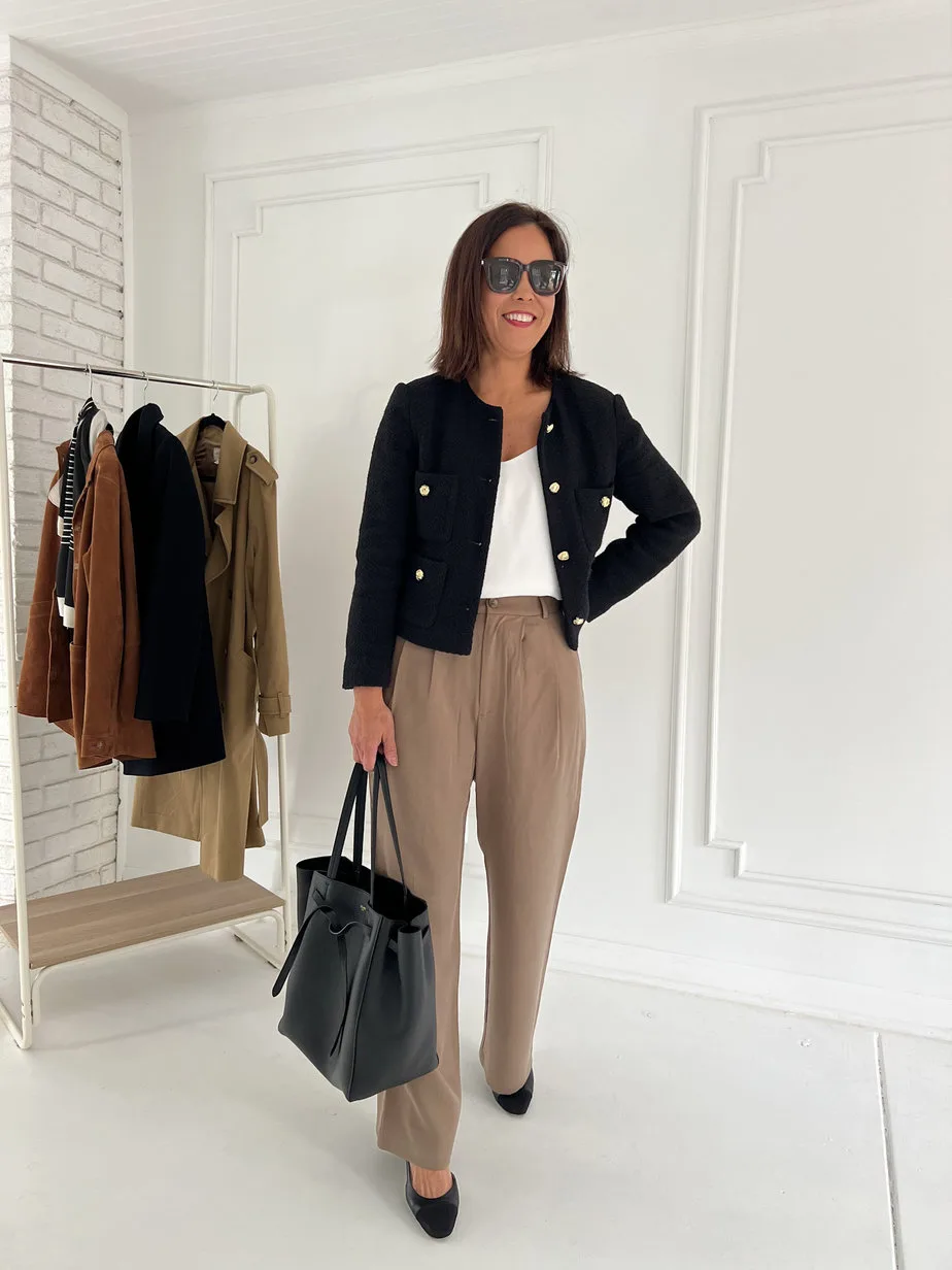 Wearing black tweed blazer with trousers, black chanel slingbacks and black celine tote.