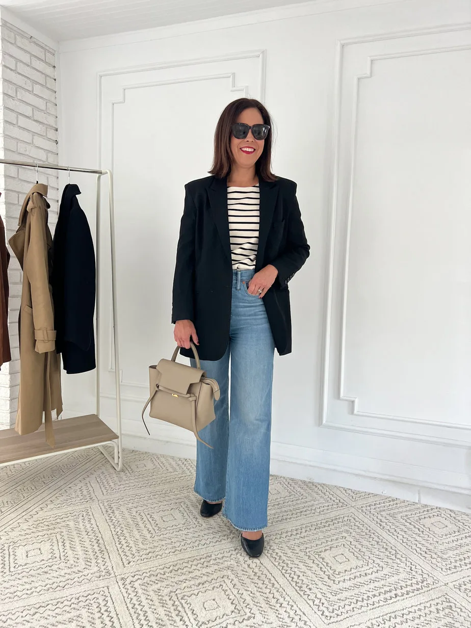 Wearing striped top with black blazer and blue denim plus black pumps.