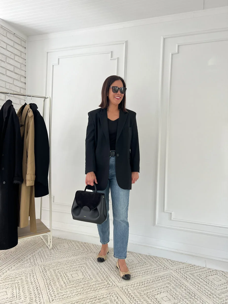 Wearing black blazer with black tee, denim, chanel flats, and black handbag for french look.