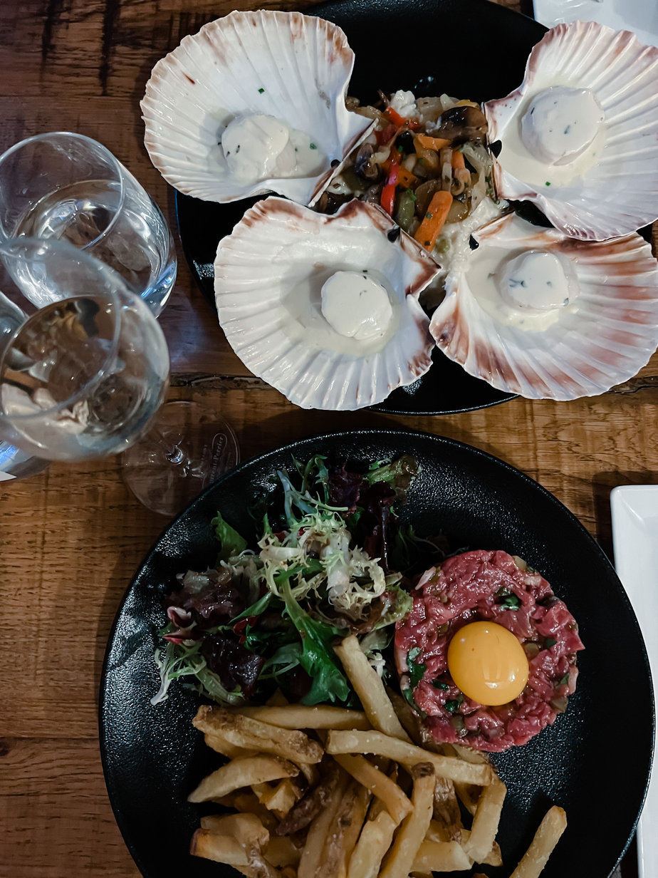 Table shot of steak tartare and scallops on a table