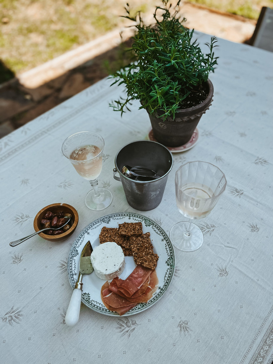 cheese and prosciutto on a plate with rose
