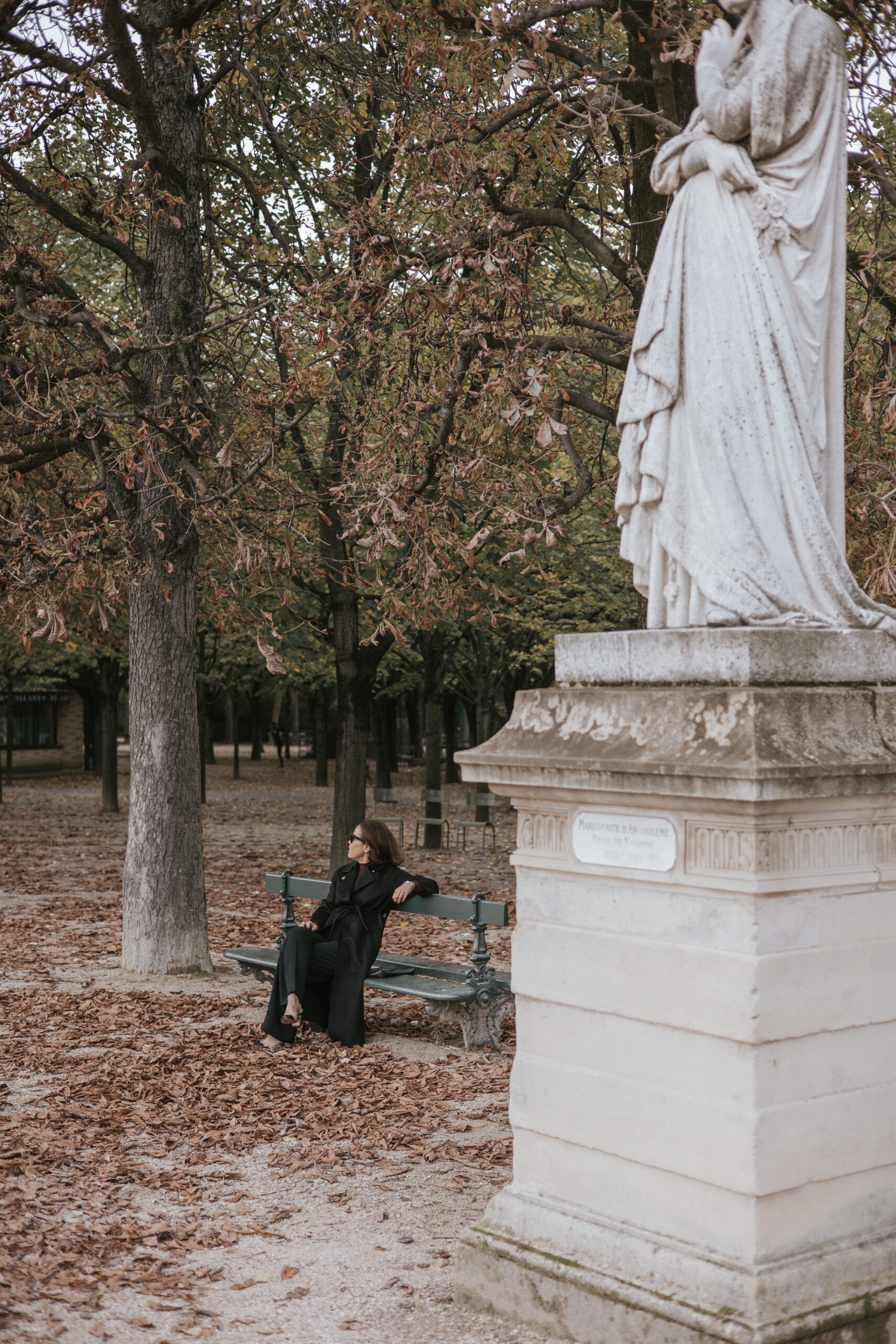 luxembourg gardens colder months Woman in luxembourg gardens in Paris during colder months.