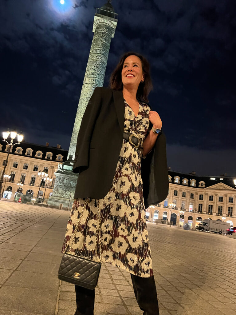 Paris street style Standing in Paris and my street style of a colorful dress with black boots and leather bag.