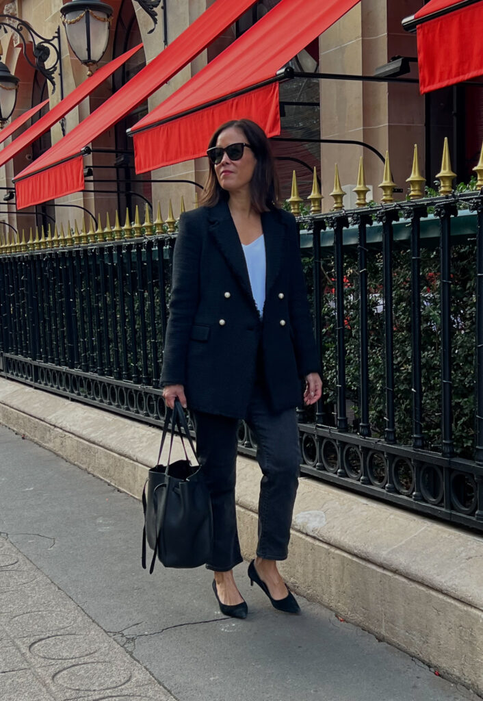 Wearing black tweed blazer with jeans and kitten heels in Paris.