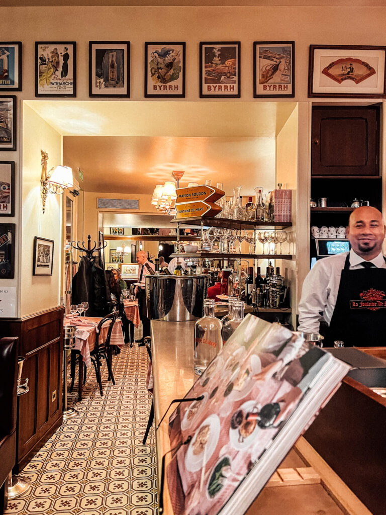 Guy standing at counter of Fontaine de Mars in Paris