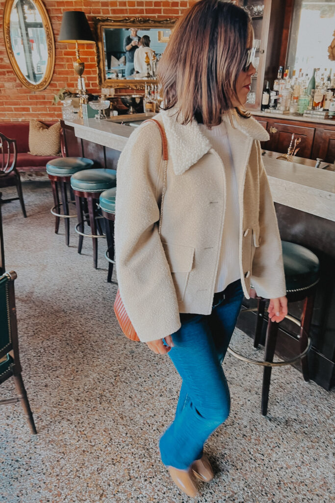 Girl wearing cream boulce coat with jeans | French Girl Inspired Winter Coats