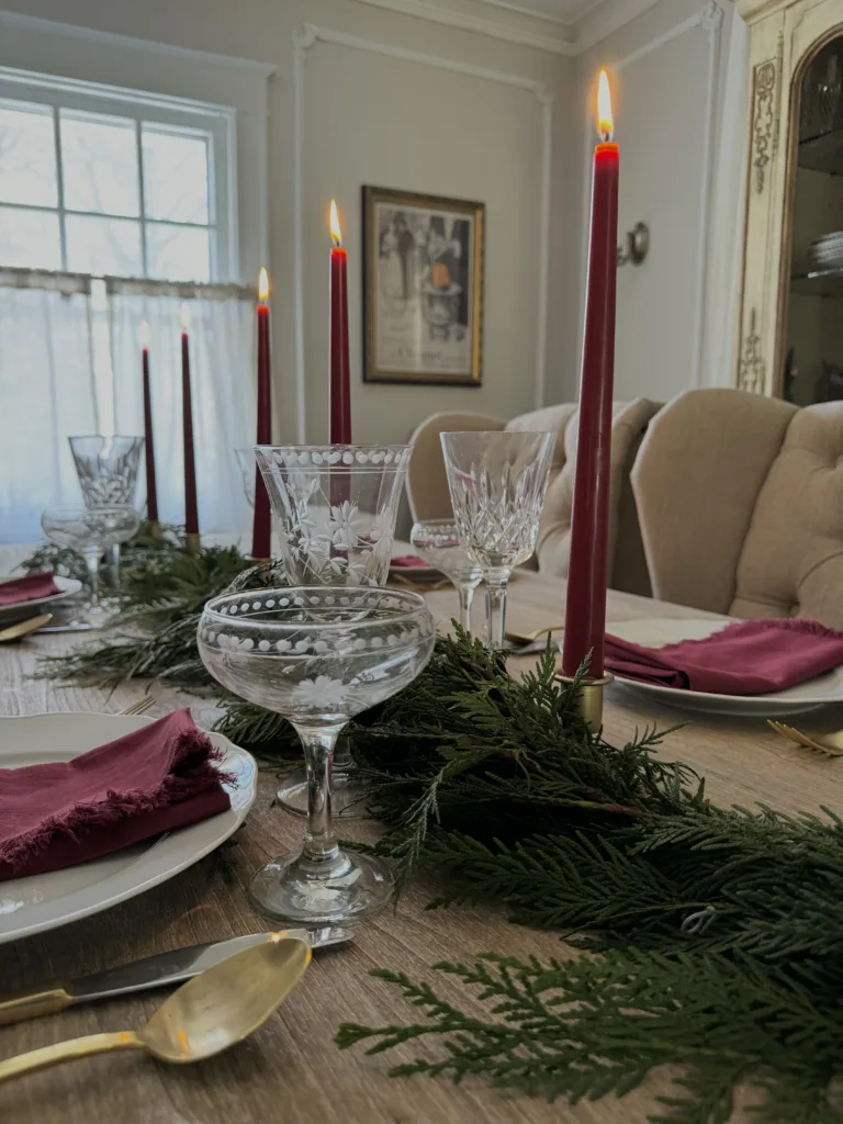 French table Candles on a table with plates and linen napkins.