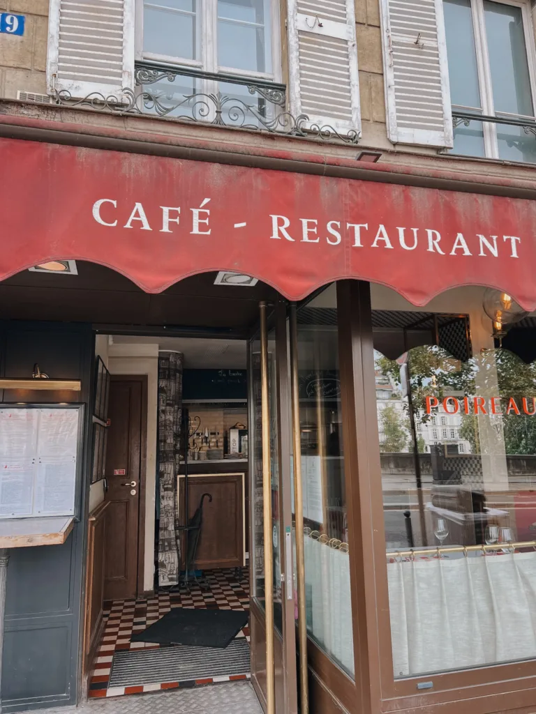 Outside red awning of a restaurant in Paris
