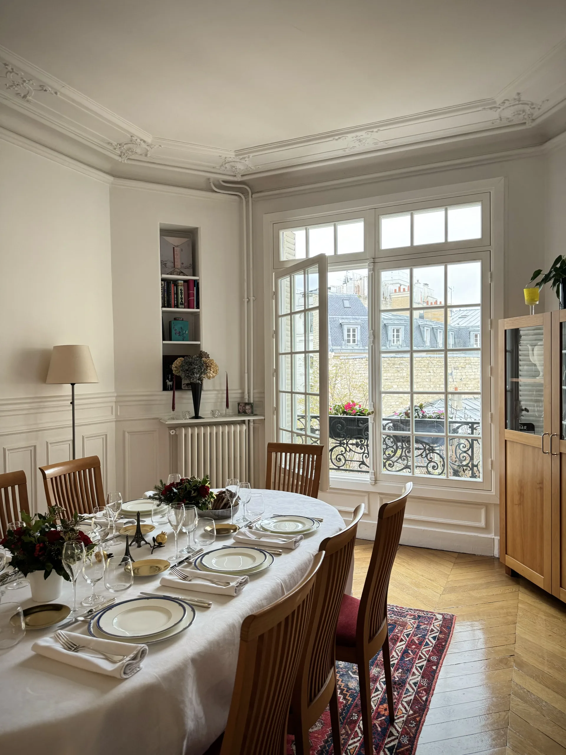 Big Parisian window with table and chairs.