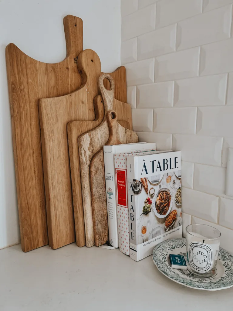 French cutting boards with 3 French cookbooks leaning against sitting on kitchen counter.