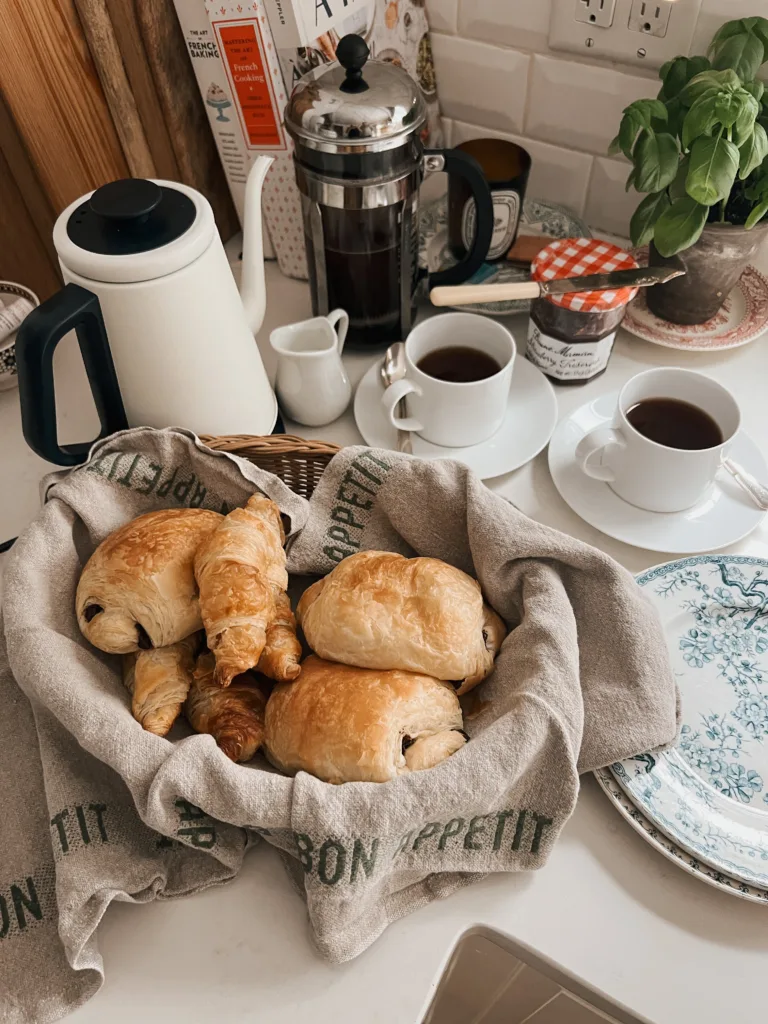 Croissants and coffee sitting on a table.