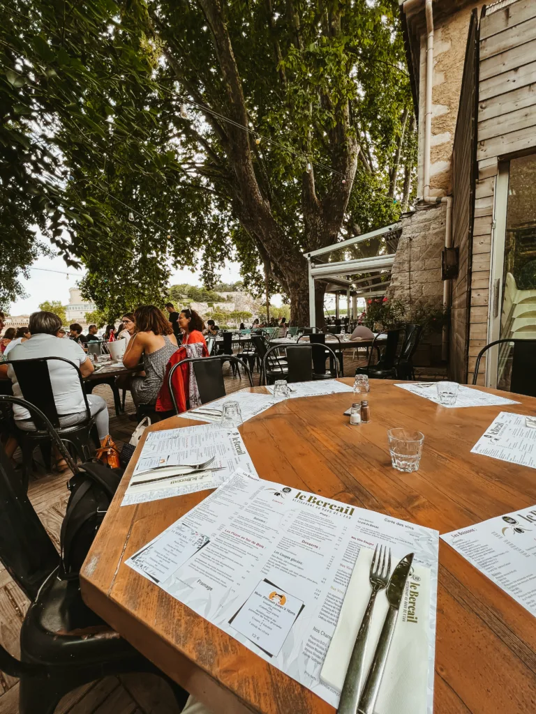 Le Bacail restaurant Le Bacail restaurant in Provence with white menu sitting on a table outside.