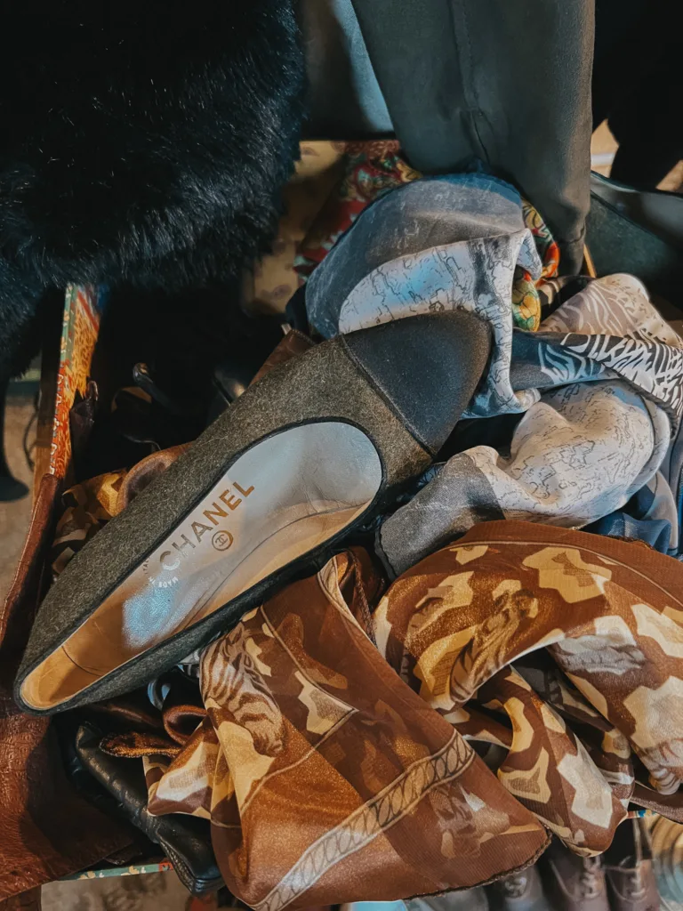 Chanel cap toe shoe sitting in old box with scarves.