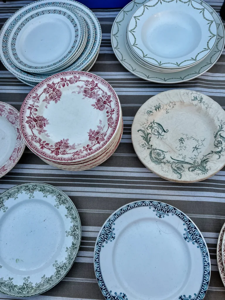 Vintage French plates on a table which are red and green.