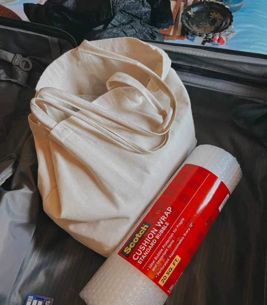 Bubble wrap and canvas tote sitting in a suitcase.