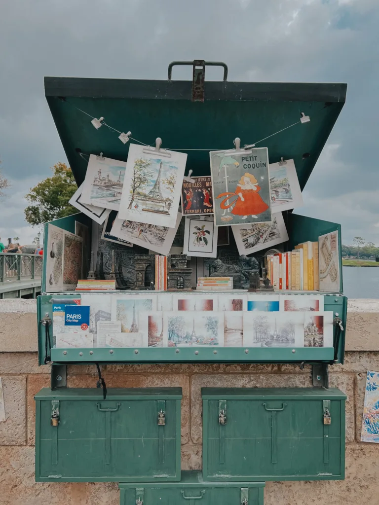 French inspired things at Disneyworld like this vendor stall hanging with French pictures in Epcot, along the Seine.