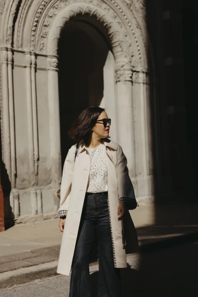 Wearing a trench coat like a French girl with dark denim and eyelet top.