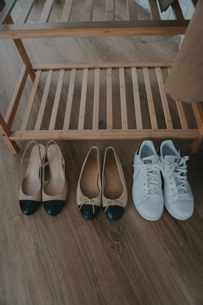 3 pairs of shoes sitting on the ground.