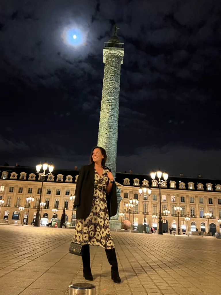 Woman wearing boots standing outside in Paris at night | A Guide To Sézane Sizing