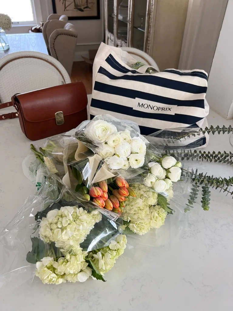 Flowers and french market tote sitting on counter.