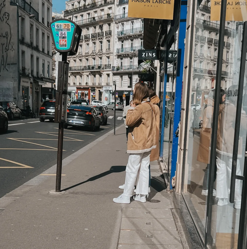Lady in Paris wearing white cropped denim with shearling jacket.