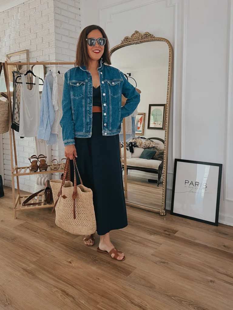summer bag Woman wearing a denim jacket with navy dress and sandals for a french inspired memorial day sale.