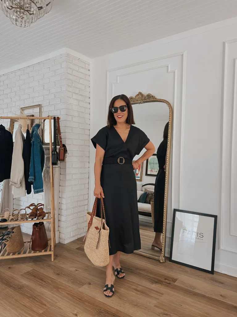 black linen dress Woman standing with mirror behind her in a black linen dress.