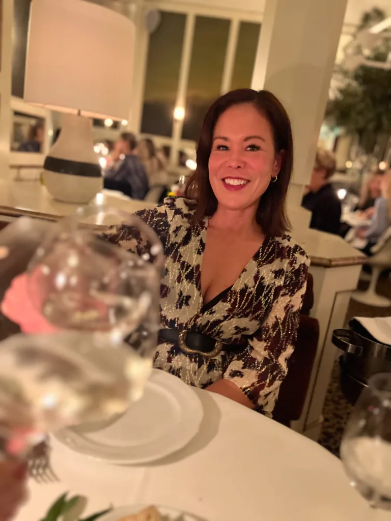 Lady in Paris restaurant Lady wearing dress giving a toast at a restaurant.