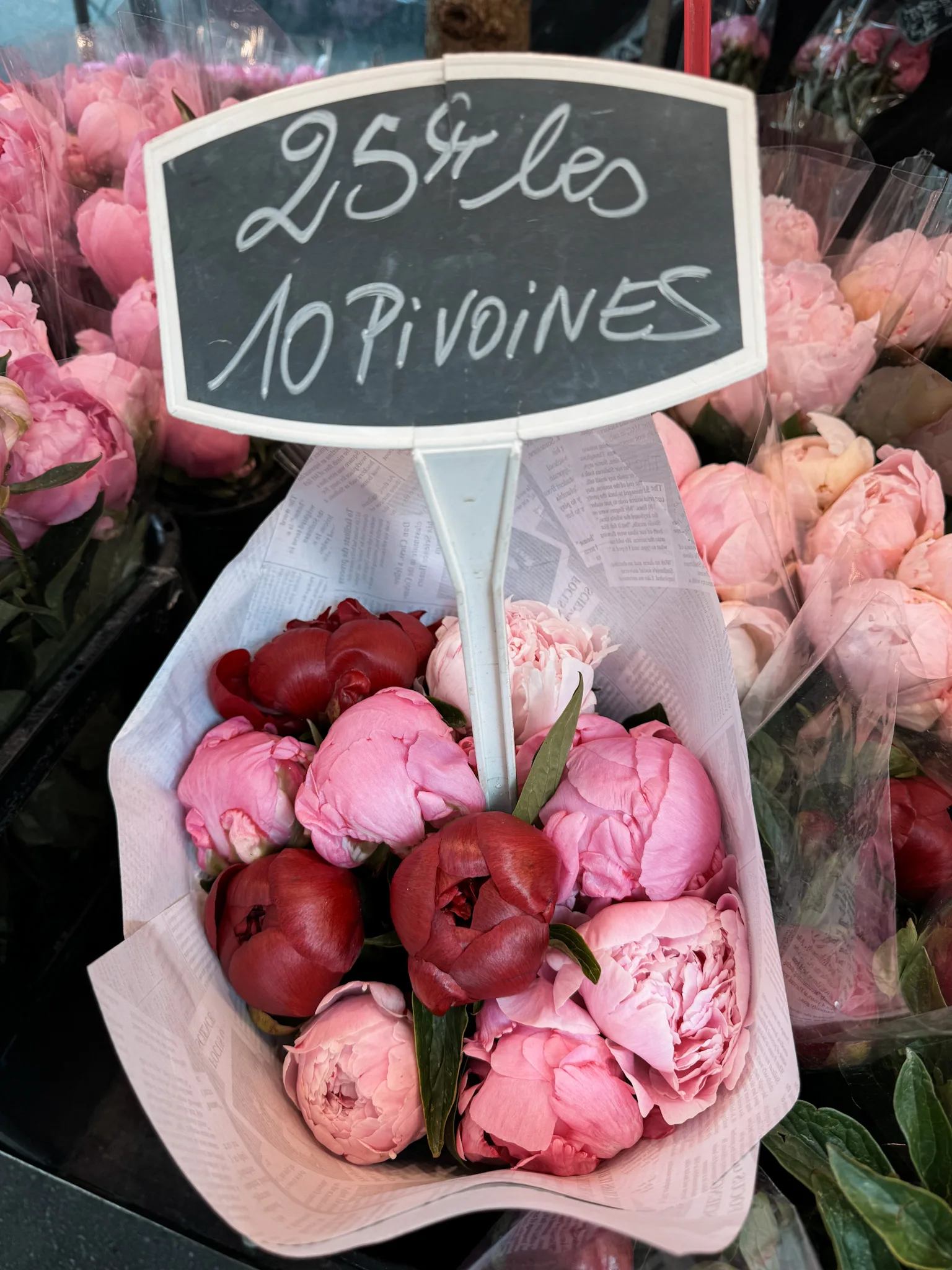 photo of Peonies in market in Paris in summer. 