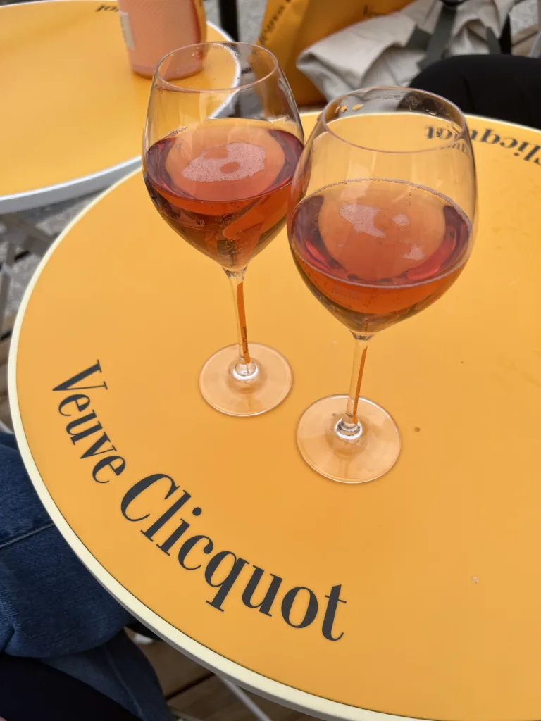 Two glasses of rose sitting on veuve cliquot table in France.