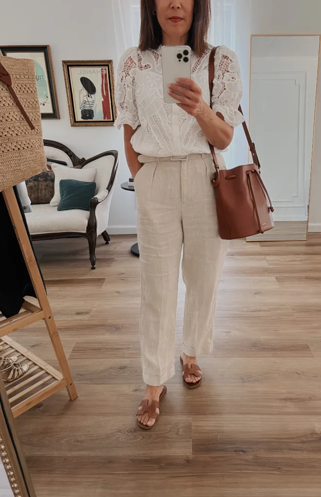 Lady wearing linen trousers with white top and sandals for french inspired pieces for summer.