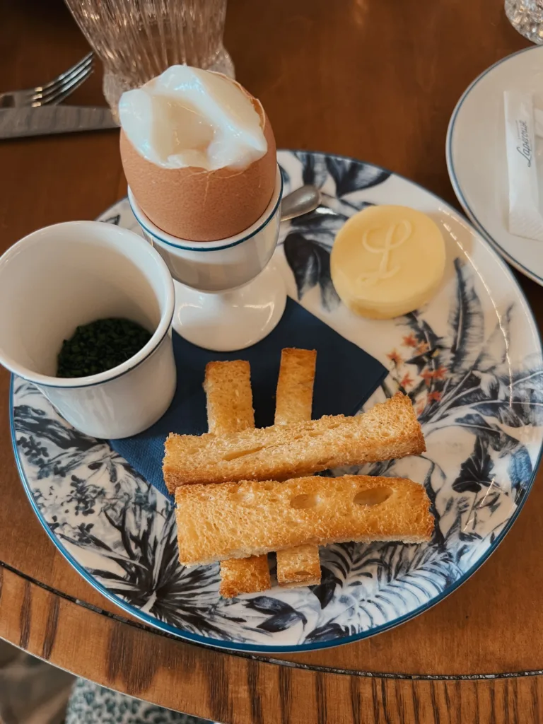 Oeufs Mouillettes Oeufs Mouillettes - Eggs and bread sitting on blue and white plate.