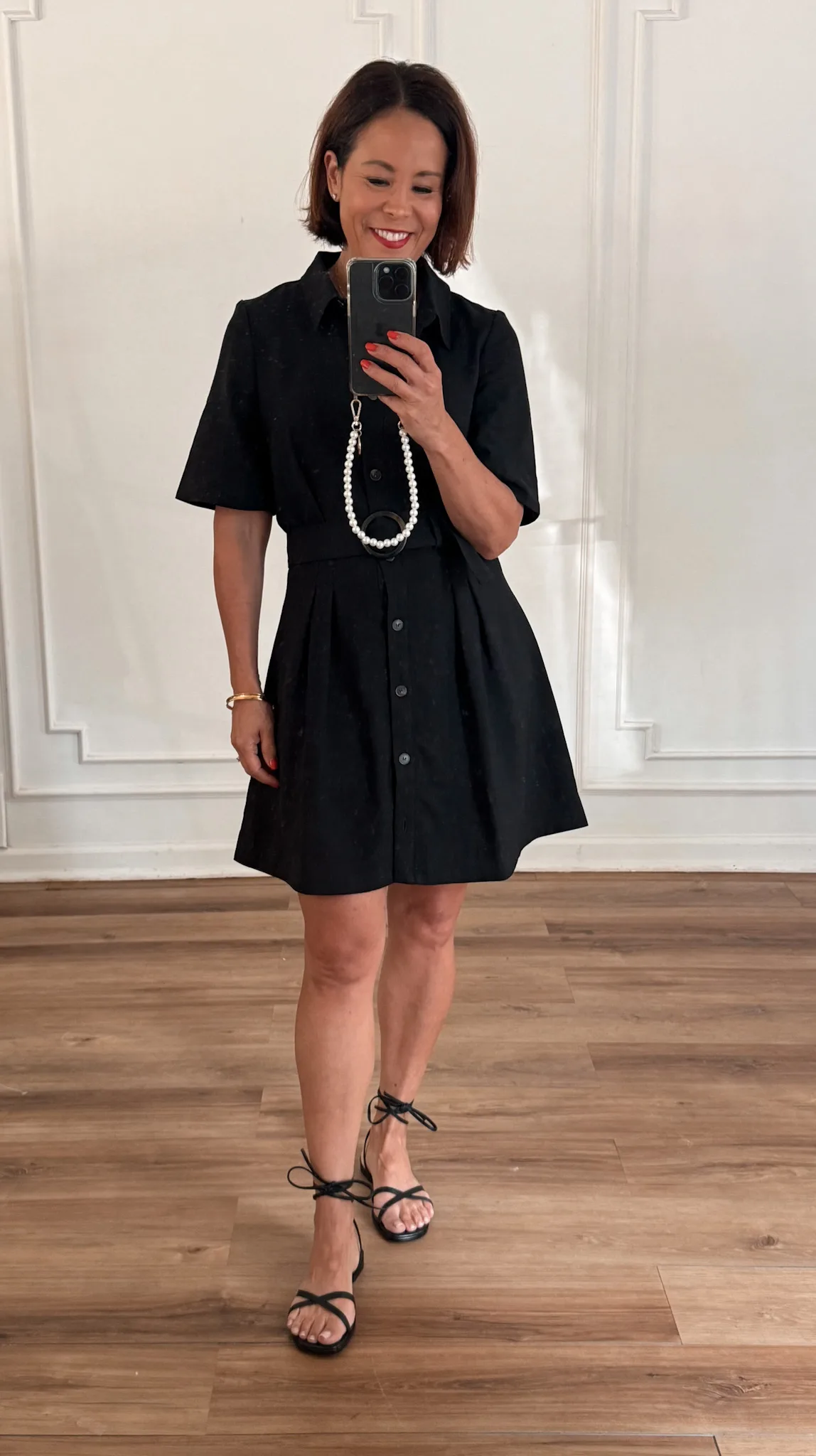 Woman wearing black LBD dress.