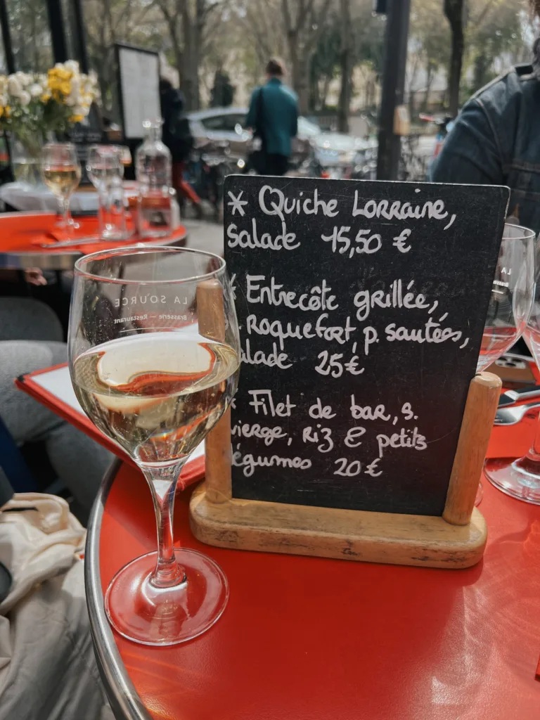 French writing on small chalkboard French writing on a small chalkboard sitting on a table.