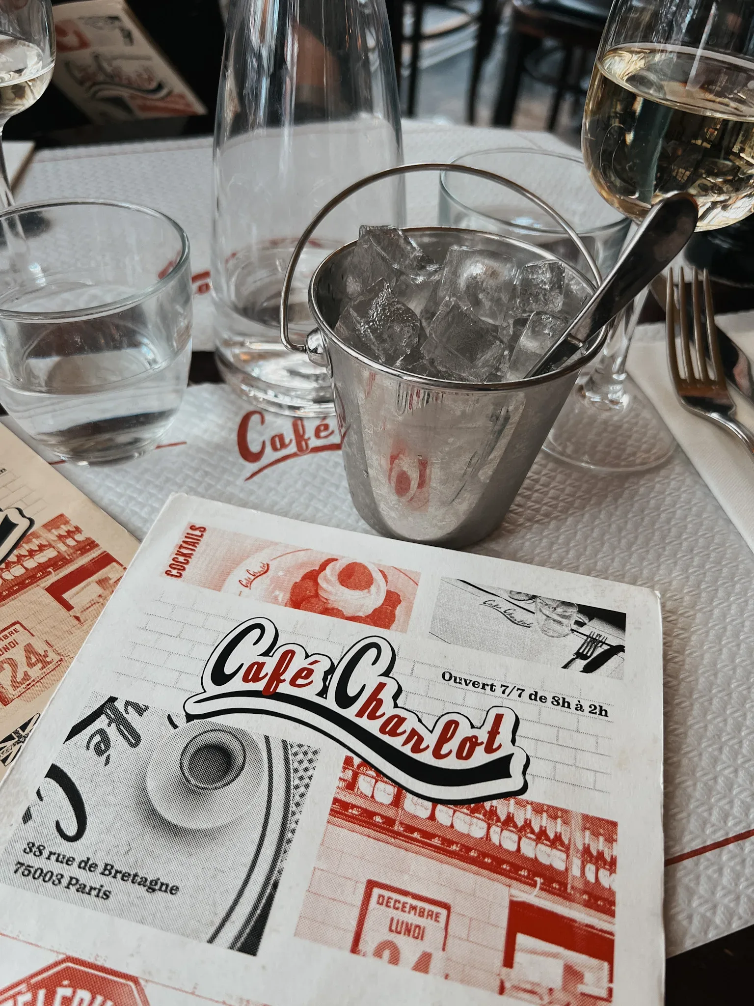 Cafe Charlot menu in Paris with bucket of ice on a table.