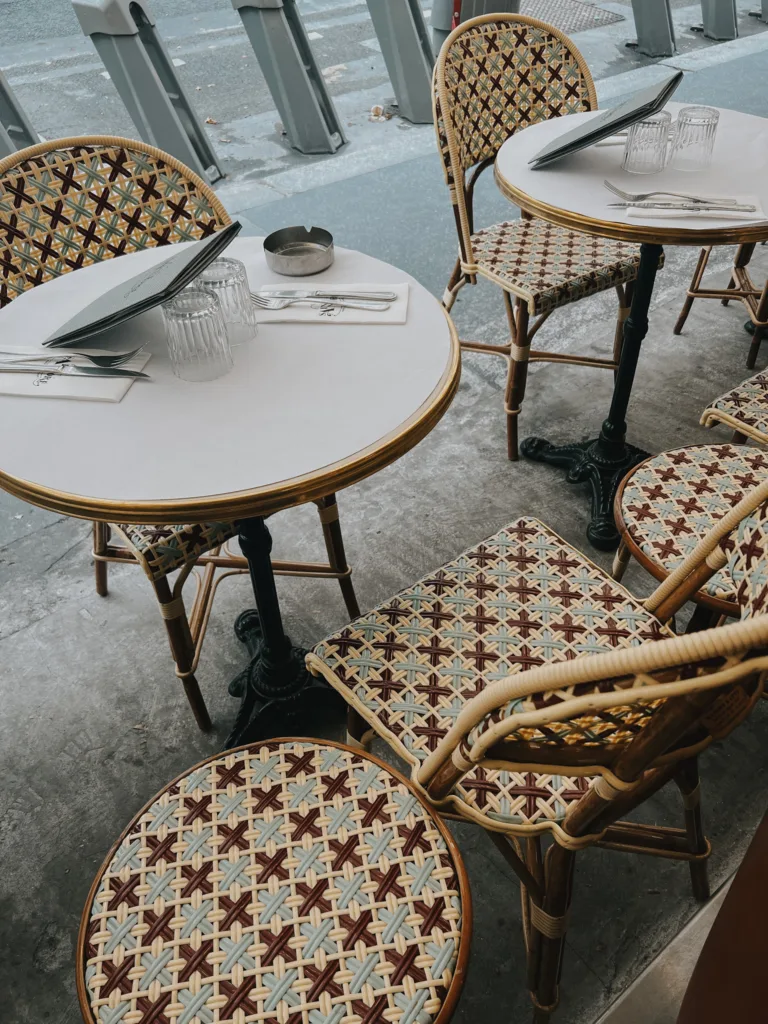 Table and chairs outside St. Andre Cafe In Paris.
