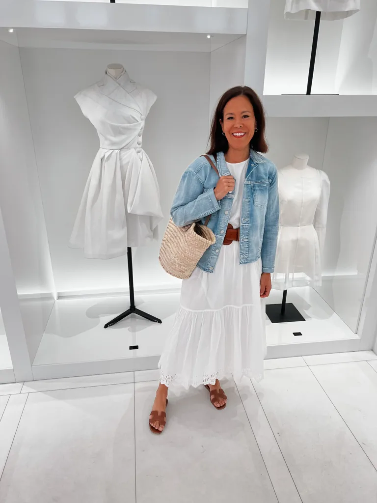 Paris white dress outfit Woman in white dress with denim jacket and sandals.