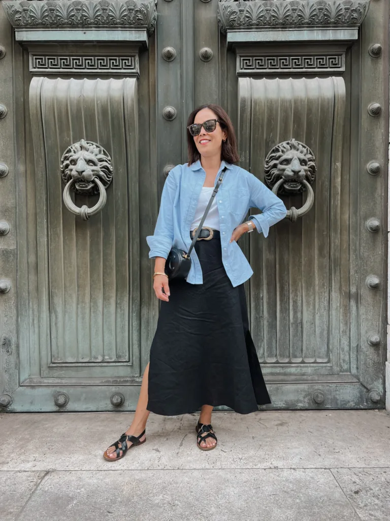 black linen skirt with blue button down Woman in black linen skirt with blue button down.