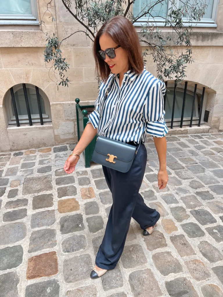 navy and white striped top with navy silk trousers Woman wearing navy and white striped top with navy silk trousers.