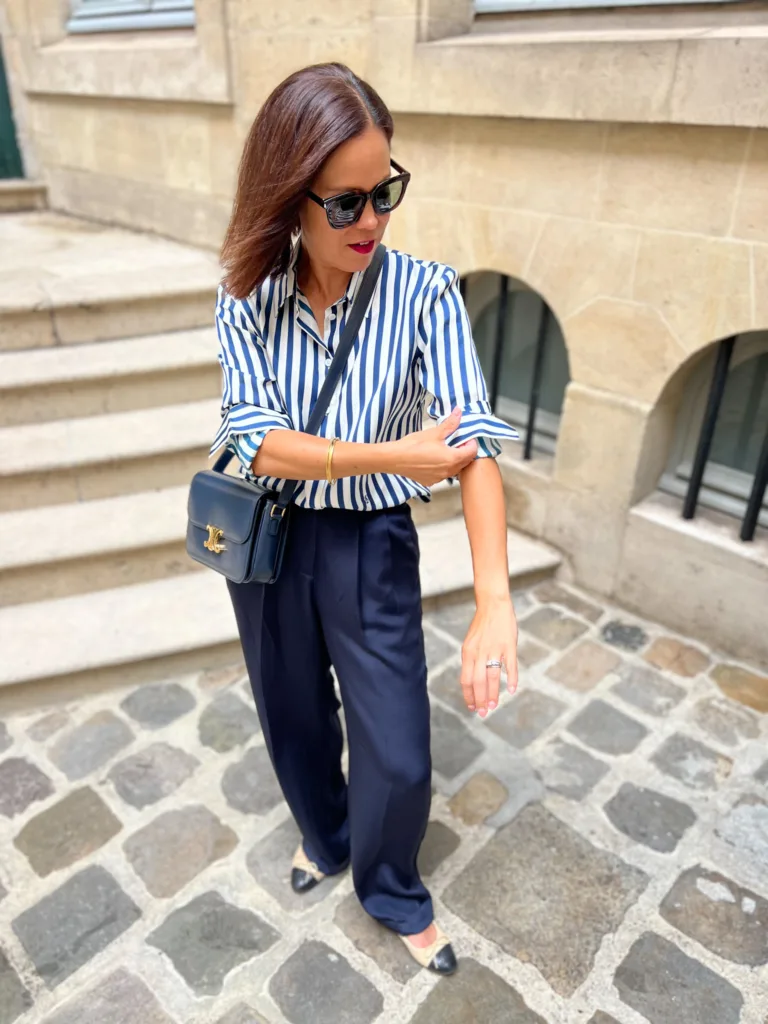 Navy blue and white striped top Navy blue and white striped top with navy trousers.