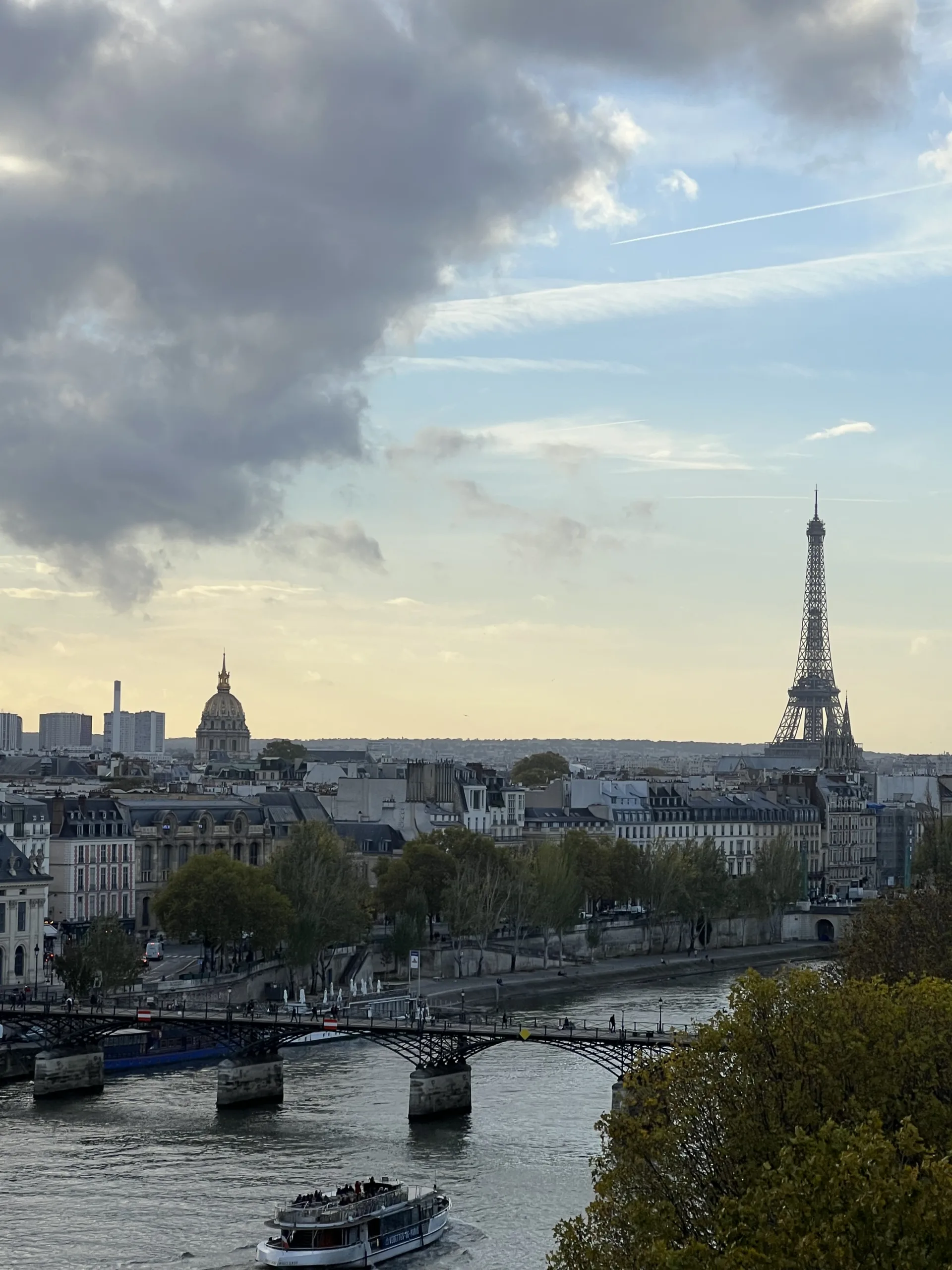 What to pack for Paris in March and the spring season. Picture of the eiffel tower and Parisian sky.
