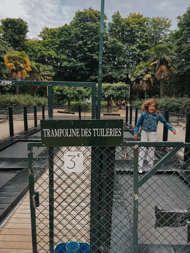 girl jumping on a trampoline in the Tuileries.