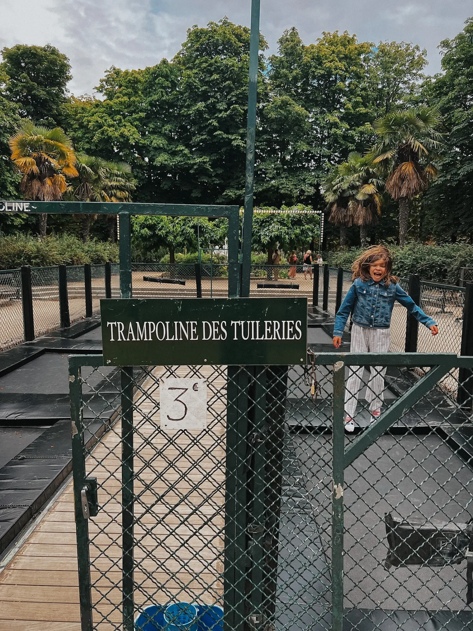 girl jumping on a trampoline in the Tuileries.