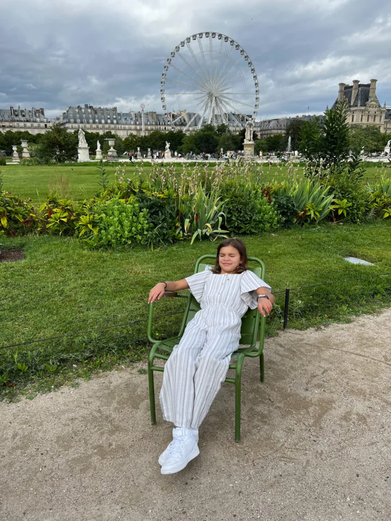 Little girl relaxing in the Tuileries Garden.