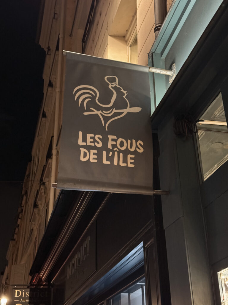 Exterior sign of Les Fous de l'ile in Paris.