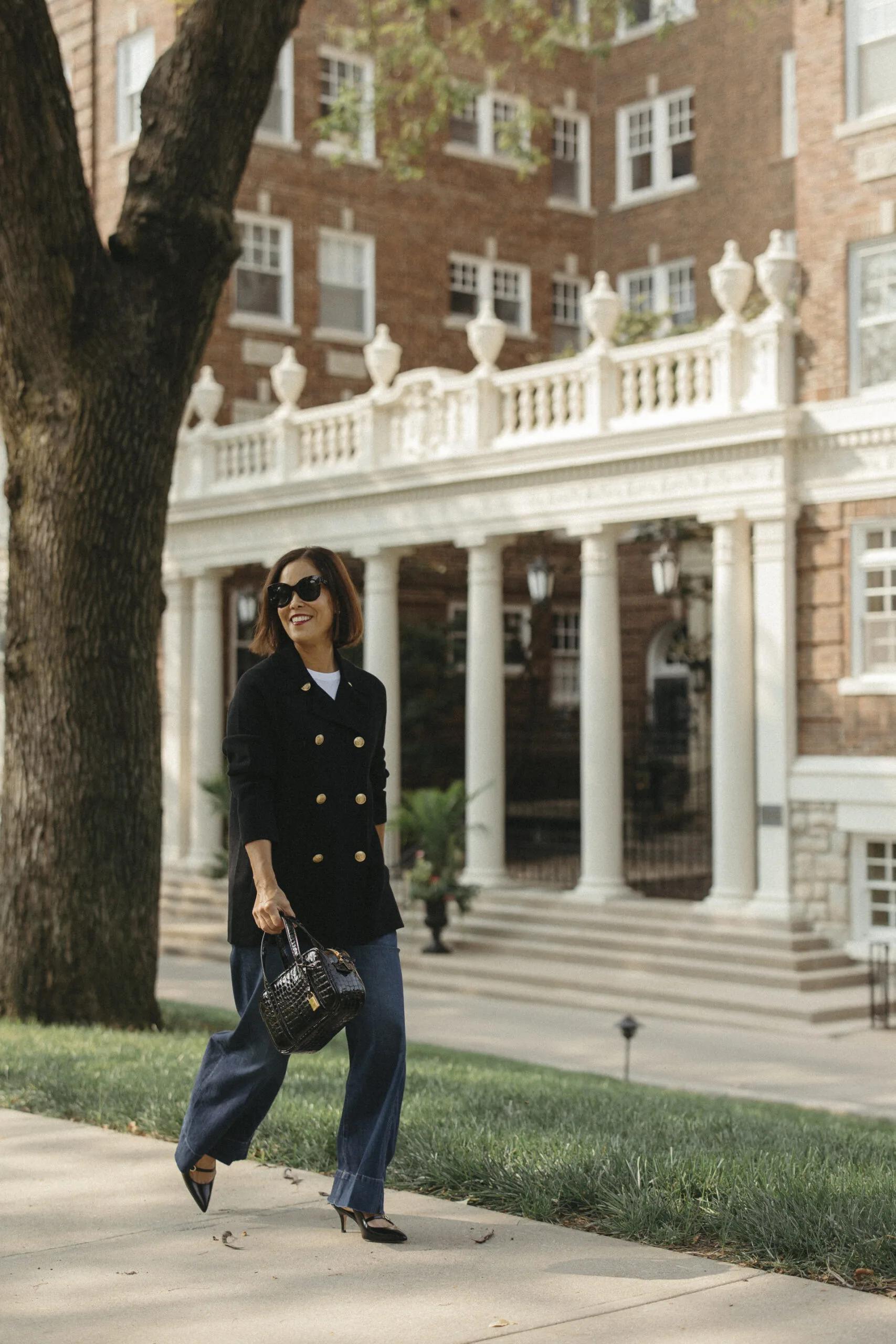 Woman wearing black j.crew sweater and denim.